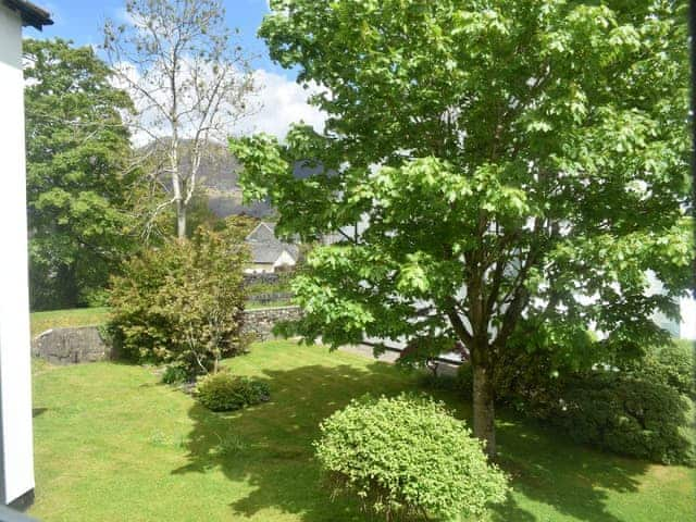 View over outdoor area from bedroom window | 14 Elm Court - Greta Grove Apartments, Keswick