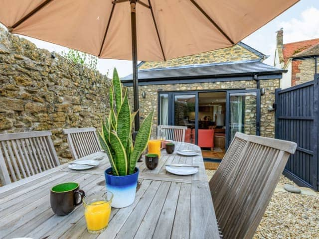 Outdoor eating area | Coach House - Bradstock Cottages, Burton Bradstock, near Bridport