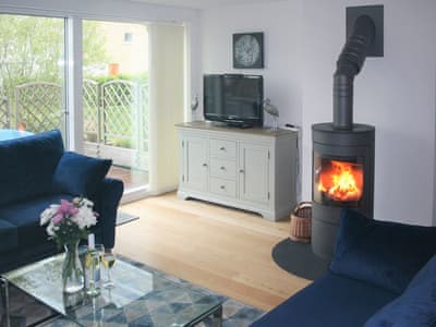 Stylish living space with wood burning stove | Chestnut Lodge, Somerford Keynes