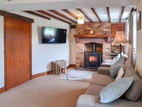 Welcoming living room with wood burner | Greenrigg Cottage, near Caldbeck