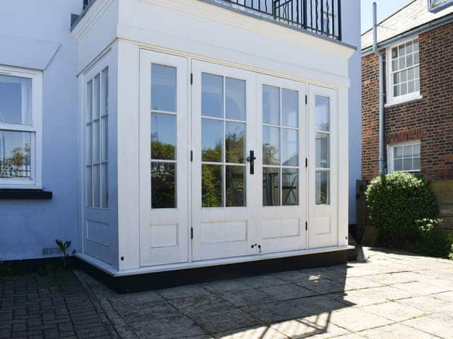 Paved patio accessed from the conservatory | Oyster Cottage, Whitstable