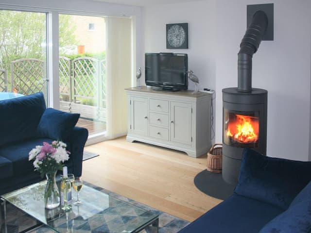 Stylish living space with wood burning stove | Chestnut Lodge, Somerford Keynes