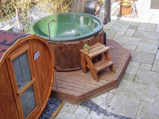 Hot tub and sauna seen from bedroom | Willowfield Cottage, Thornton-Le-Dale