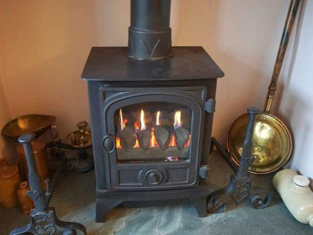 Gas stove in the living room | 3 Catherine Cottages, Keswick