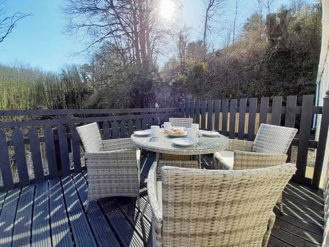 Private decking area overlooking pond and woodland | Graylings Rest - Brigham Holiday Park, Brigham, near Cockermouth