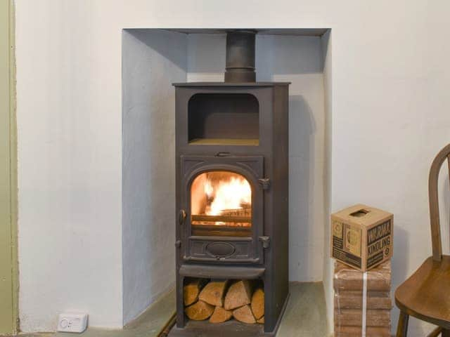 Woodburner in the kitchen/diner | Campbell Cottage, Windermere