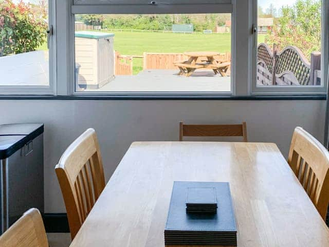 Dining area overlooking the decking | Beachcomber, Mundesley, near North Walsham