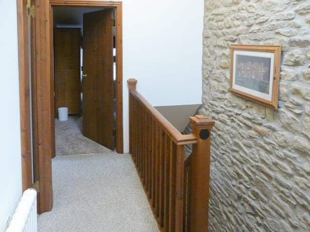 The stairs lead up to a landing with origional stone walls | Hollin Bank Cottage, Salterforth, near Barnoldswick