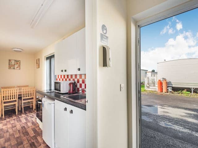 Kitchen/diner | Rainbow Bungalow 1 - Kings Caravan Park, Chapel St Leonards