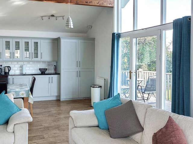 Open plan kitchen dining area with double height window | Mahonia Lodge, Warkworth