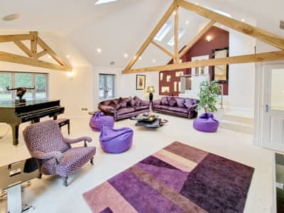Stylish open plan living room complete with mini grand piano and 70 inch TV screen | The Lodge, North Duffield, near York