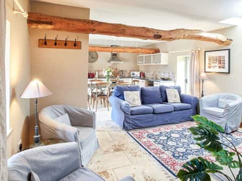 Open plan living space with beams and marble floor | The Piggery - Manor Mews, Tattersett, near Fakenham