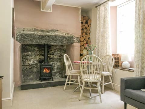 Dining area with log fire | Tryfan - Red Dragon Cottages, Beddgelert