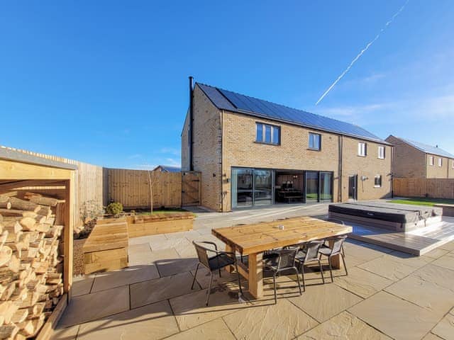 Hot tub, BBQ area and wood store | Eastgate Barn - Ashlin Farm Barns, Dunholme, near Lincoln