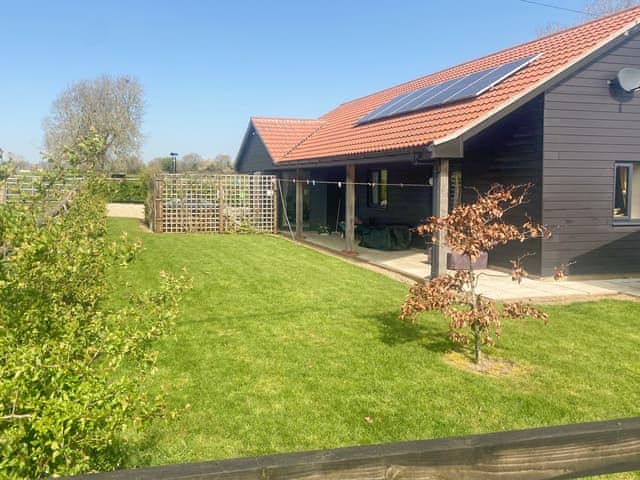 Exterior rear garden backing onto pastures | Moor Farm Lodge, Foxley, near Dereham