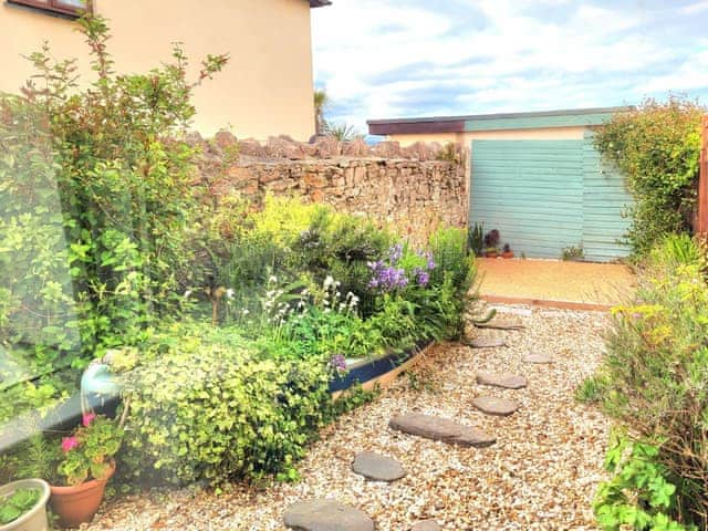 Enclosed courtyard with sitting out area | Honeysuckle Bay Cottage, Brixham