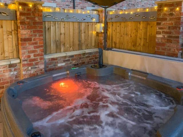 Coloured lights within the hot tub | White Heather Barn, Swanwick