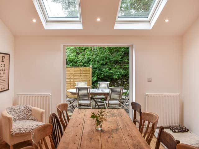 Kitchen french doors open onto enclosed garden patio and dining area | Nurses Cottage, Askham, near Penrith