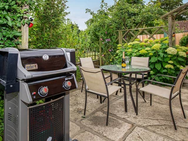 Lawned garden with patio, garden furniture and gas BBQ | The Weaning Shed, Huggate, near York