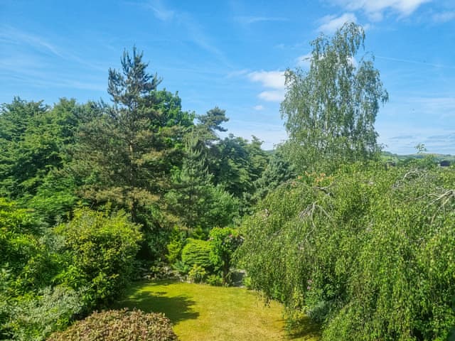 View of the garden from the balcony | Harwood Dale Cottage, Kendal