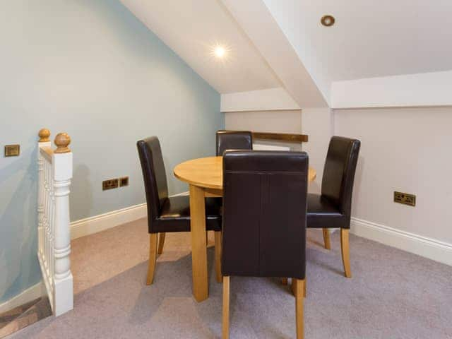 Attractive dining table overlooking the living area | The Granary - Holtby Grange Cottages, Holtby, near York