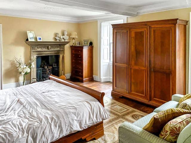 Master bedroom (1st floor) with super king size bed and original fireplace | Bradley Hall, Matlock