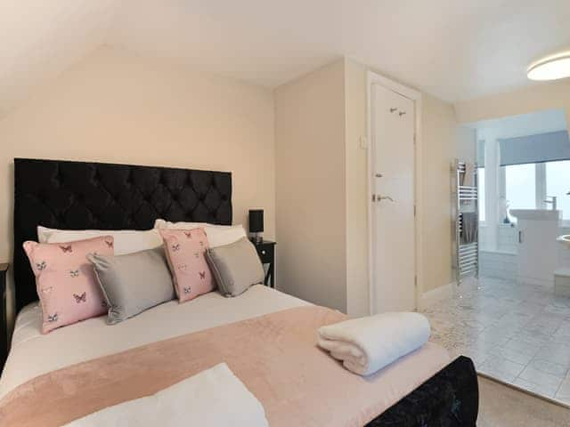 Bedroom 4 with open plan bathroom | Beaconsfield House, Mundesley