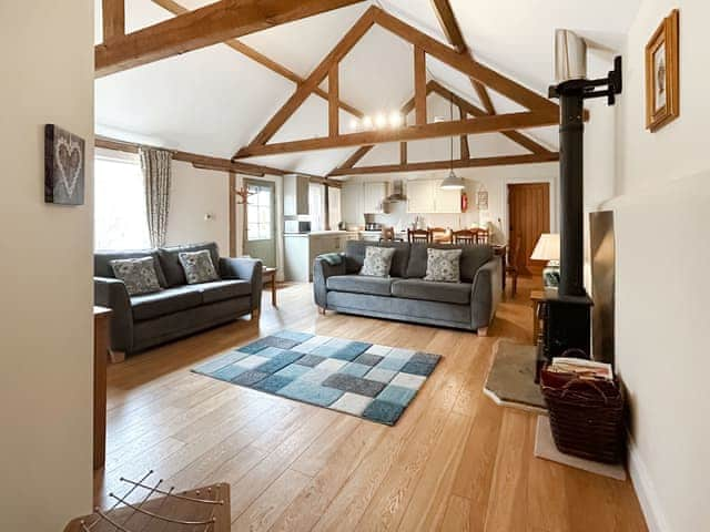 Open plan living space boasting character features, oak flooring and woodburner | Squirrel&rsquo;s Drey - Manor Farm Barns, Witton, near Happisburgh