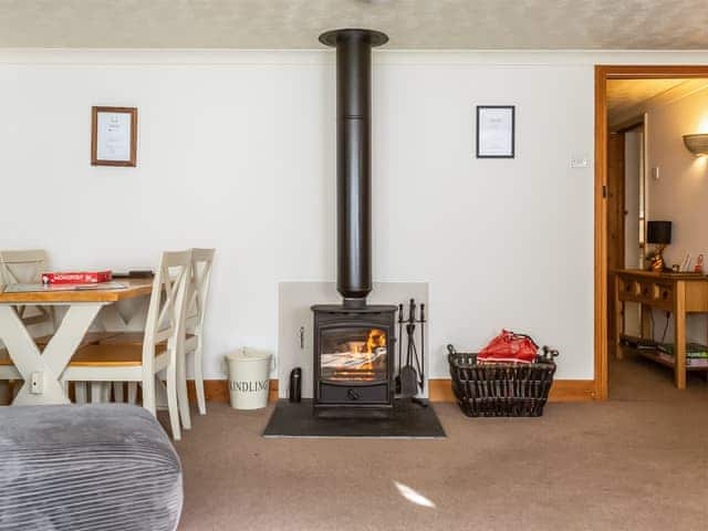 Inviting living/ dining room with a wood burner | The Nook, Whitecroft, Forest of Dean