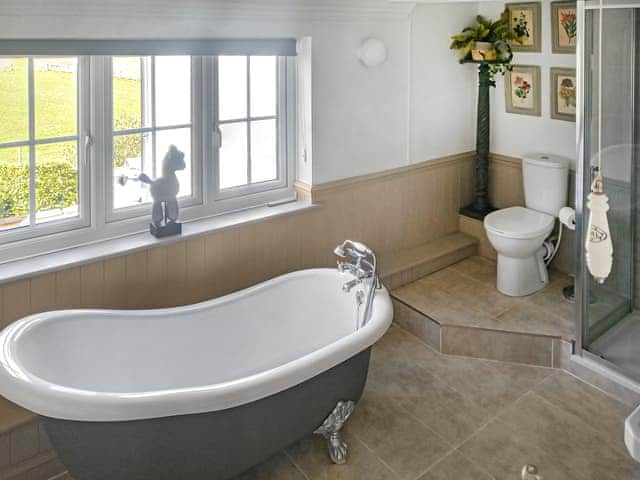 Attractive bathroom with roll-top bath and separate shower enclosure | Walnut Tree House, Tilney St Lawrence, near Kings Lynn