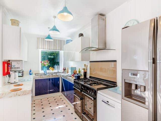 The kitchen with american fridge freezer, double range cooker is adjacent to the lounge dining area | Tregarrek, Helston & The lizard