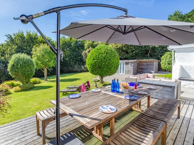 Step out of the dining area to your spacious rear deck overlooking the huge coastal private garden | Tregarrek, Helston & The lizard