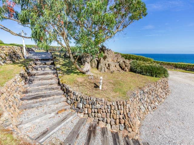 Steps lead up to the huge front terraced gardens with far reaching views from Plymouth to The Lizard | Tregarrek, Helston & The lizard