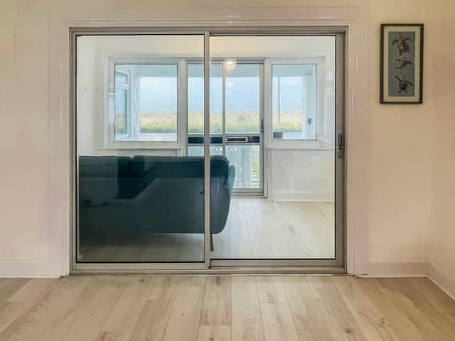 Living room looking out to the sun room | Sea View Cottage, Greatstone, New Romney