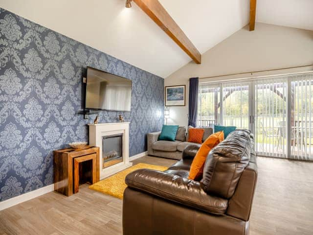 Comfortable living space with patio doors to the verandah | Humphrey-Basil Lodge - Birchdale Lodges & Alpaca&rsquo;s, Norton Disney, near Lincoln