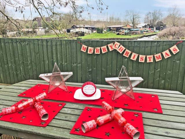 Christmas on the decking. Complementary crackers and Christmas pudding | Island Lodge, Little Baddow, near Chelmsford