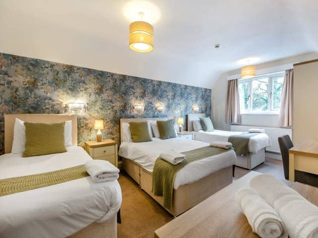 Large bedroom with a double bed and 2 single beds | Corner Cottage, Troutbeck Bridge, near Windermere