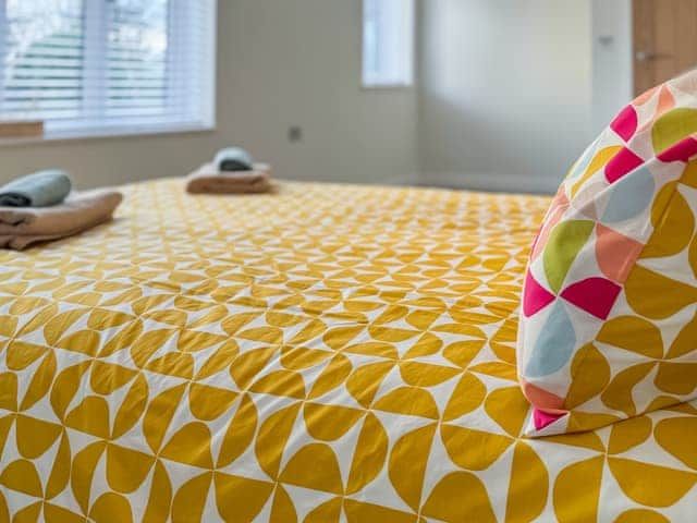 Main Bedroom with lovely twin aspect windows overlooking the tranquil woodland back garden | Seafields, Sidestrand