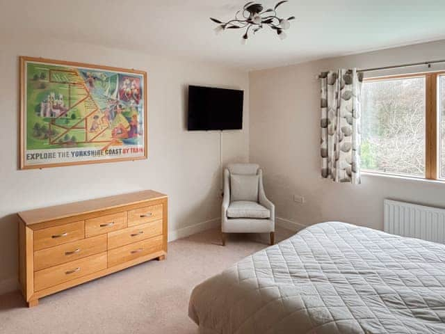 Main bedroom with wall mounted smart tv | Seagull Apartment, Scarborough