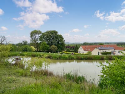View across widlife pond in grounds towards Wendys Wing | Wendys Wing - Greetham Retreat, Greetham, near Horncastle
