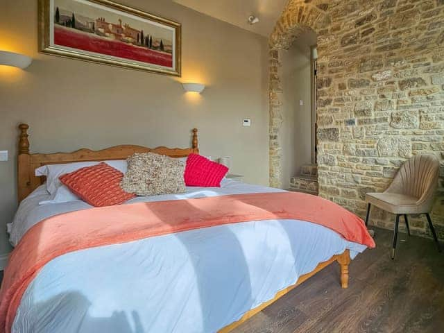 Master bedroom with en-suite 17th century stone wall and beems | Stone Cottage, Maltfield, near Wedmore