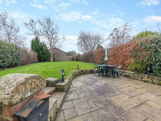 Garden showing large patio | Bumble Cottage, Newton-on-the-Moor, near Alnwick