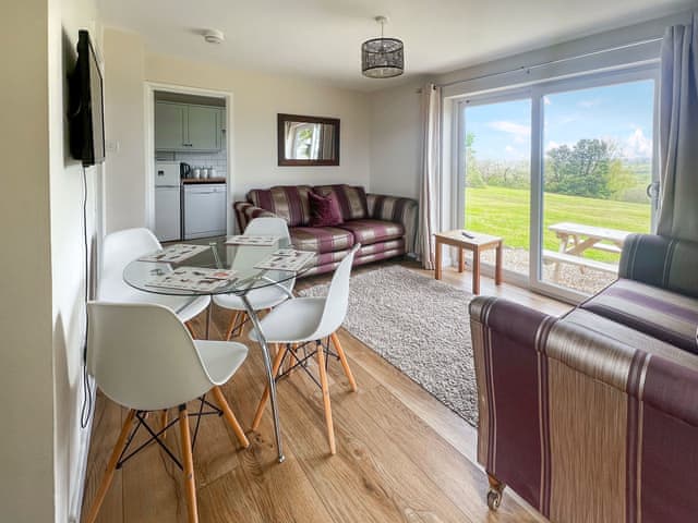 Living and dining area with amazing views across the countryside | Jasmine Apartment - Moorhead Country Holidays, Woolfardisworthy, Clovelly