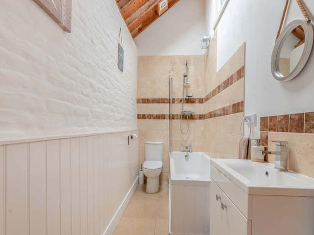 Bathroom with shower over bath | The Waggon House - Milton End Farm Barns, Arlingham, near Frampton-on-Severn