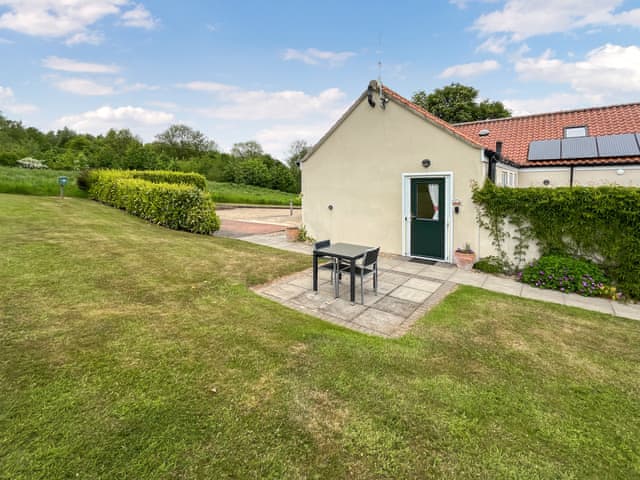 Front door to Wendy’s Wing and small paved patio area with table & chairs | Wendys Wing - Greetham Retreat, Greetham, near Horncastle