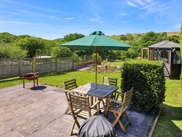 Patio and back garden | Dunstone Cottage, Cadover Bridge