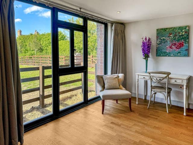 Part of the second en-suite bedroom with view view over the front paddock | Barn Owl Cottage - Home Farm Retreats, Kirk Hammerton, near York