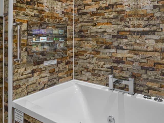 TV over the jacuzzi bath | The Old Stables, Rothbury