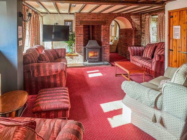 middle lounge with log burner | Orchard Barn - Duvale Cottages, Bampton, near Tiverton