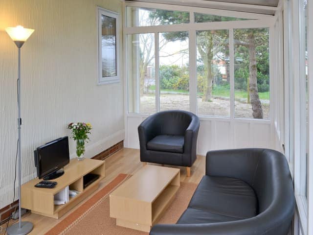 Conservatory with seating and TV | Seacroft, East Runton, near Cromer